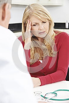 Worried Mature Woman Meeting With Doctor In Surgery