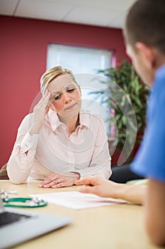 Worried Mature Woman Meeting With Doctor In Surgery