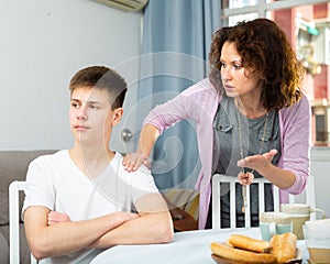Worried mother scolding teenage son