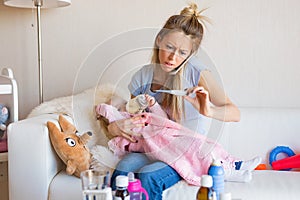 Worried mother with sick baby calling doctor