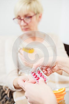 Worried mother taking medications from her daughter. Selective focus concept, focus on foreground