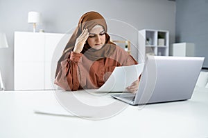 Worried Muslim Woman Doing Taxes