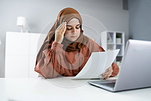 Worried Muslim Woman Doing Taxes
