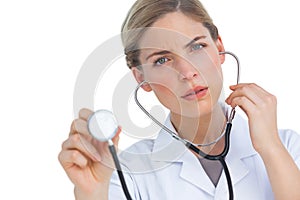 Worried nurse listening to stethoscope