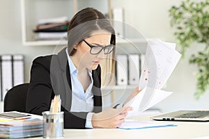 Worried office worker reading sales reports