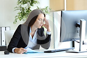 Worried office worker suffering headache