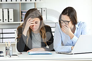 Worried office workers discovering a mistake photo