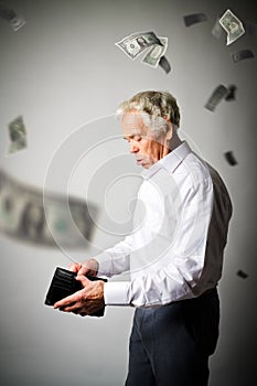 Old man in white and empty wallet. Falling dollars and taxes.