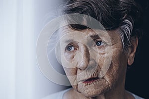 Worried old woman`s face photo