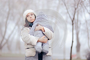 Worried Overprotective Mother Holding baby in Cold Weather