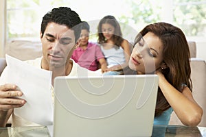 Worried Parents Using Laptop At Home