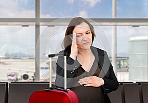 Worried pregnant woman at the airport