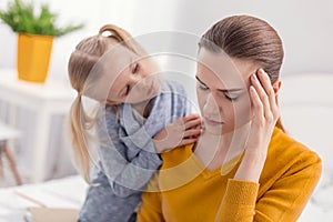 Worried pretty daughter calming down mom
