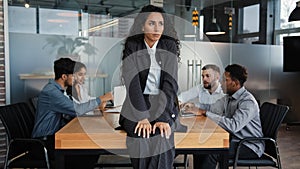 Worried sad upset leader woman worker businesswoman sitting on table in conference room thinking about business problem