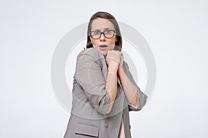 Worried scared woman in glasses being afraid looking at camera