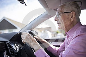 Worried Senior Male Driver Looking Through Car Windscreen