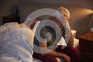 Worried Senior Man In Bed At Night Suffering With Insomnia