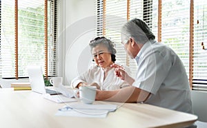 Worried Senior man and woman having problem talk about Financial economic crisis. Stressed Asian Elderly Couple discussing and