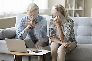 Worried senior retired husband and wife stressed about financial crisis