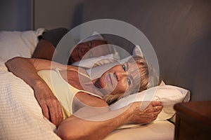 Worried Senior Woman In Bed At Night Suffering With Insomnia