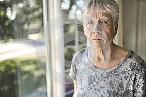 A worried senior woman at home felling very bad