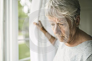 A worried senior woman at home felling very bad