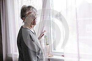 Worried senior woman at home felling very bad