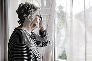 Worried senior woman at home felling very bad