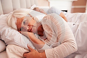 Worried Senior Woman Lying Awake In Bed photo