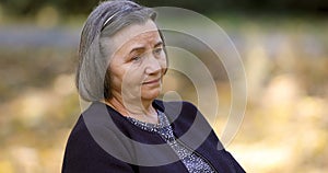 Worried senior woman outdoors