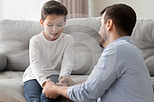Worried single father comforting upset kid son helping with problem