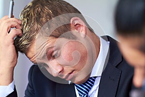 Worried and stressed businessman scratch his head