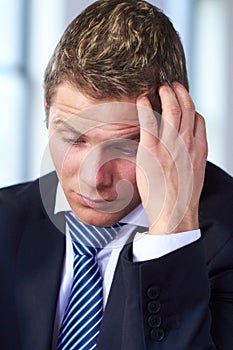 Worried and stressed businessman scratch his head