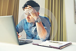 Worried stressed businessman shocked by bad news using laptop at work, desperate bankrupt investor lost money online depressed by