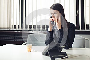 Worried stressed depressed office worker business woman receiving bad news emergency phone call at work. Looking confused