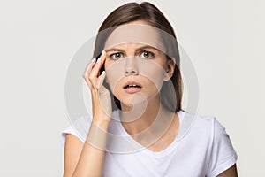 Worried stressed girl checking wrinkles on face looking at camera