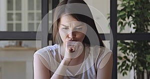 Worried stressed young woman concerned about problem making difficult decision