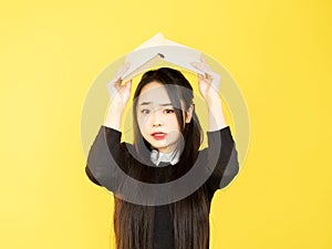 worried student school stress girl hiding book