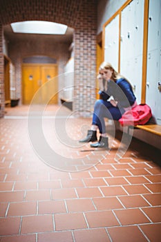 Worried student sitting with hand on head
