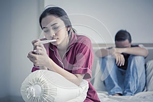 Worried teenage couple with pregnancy test photo