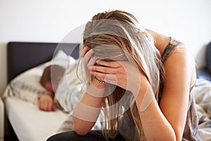 Worried Teenage Girl In Bedroom With Boyfriend