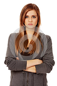 Worried teenage woman with folded arms