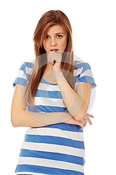 Worried teenage woman with folded arms