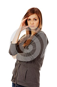 Worried teenage woman with folded arms