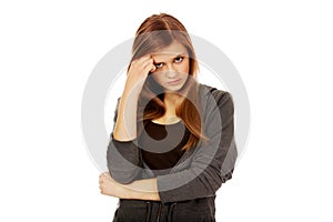 Worried teenage woman with folded arms