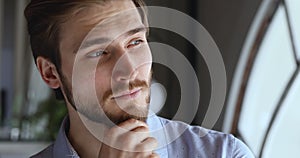 Worried thoughtful young businessman looking away thinking of future