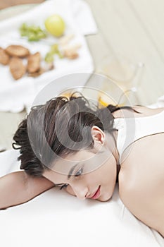 Worried woman on bed with food in the back