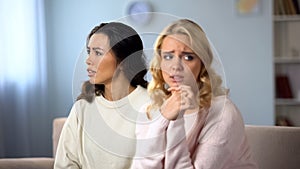 Worried woman being afraid to confess her friend, secret information, shame