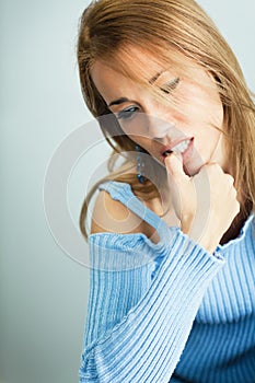 Worried woman biting her nails