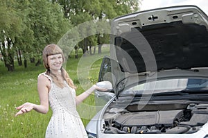 Worried woman with broken car